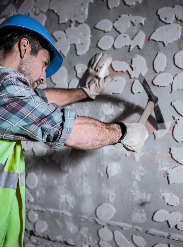 a-worker-with-a-helmet-on-his-head-hits-a-wall-wit-2025-01-07-10-31-40-utc